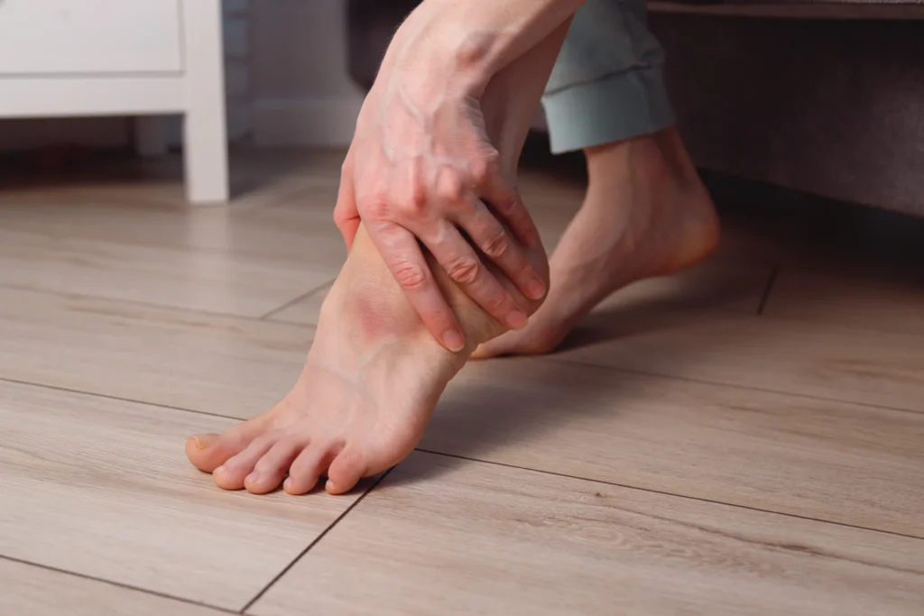 adult woman holding her foot in pain 2026 03 23 23 44 22 utc