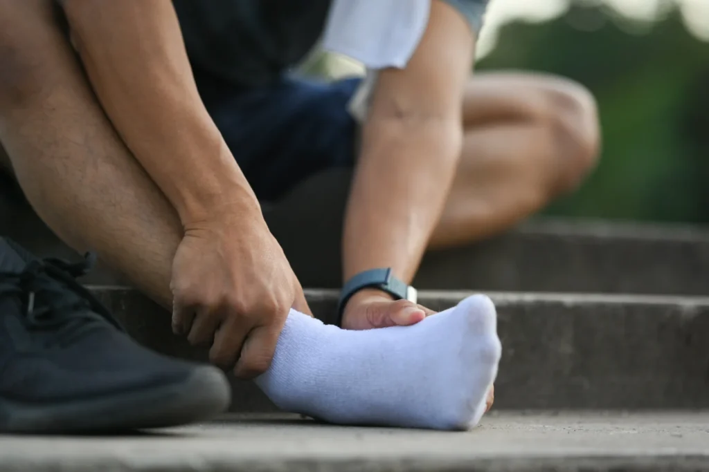 sportsman touching his sore ankle injured while t 2026 03 15 23 20 19 utc